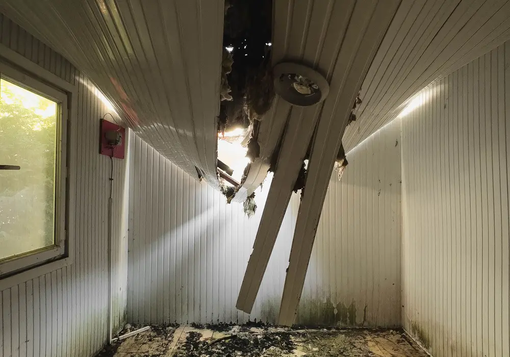 Room with a collapsed ceiling and debris on the floor